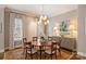 Bright dining room featuring hardwood floors, a modern chandelier, and an area rug at 2021 Nolen Park Ln, Charlotte, NC 28209