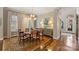 Dining room featuring hardwood floors, a modern chandelier, and a decorative sideboard at 2021 Nolen Park Ln, Charlotte, NC 28209