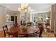 Open-concept living space featuring a dining area, hardwood floors, and lots of natural light at 2021 Nolen Park Ln, Charlotte, NC 28209