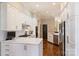 Well-lit kitchen offers stainless steel appliances, ample counter space, white cabinetry, and hardwood floors at 2021 Nolen Park Ln, Charlotte, NC 28209
