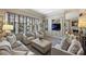 Living room with recessed lights, large windows and comfortable seating with neutral colors at 2021 Nolen Park Ln, Charlotte, NC 28209