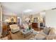 Open-concept living area with hardwood floors, a fireplace, dining area, and kitchen views at 2021 Nolen Park Ln, Charlotte, NC 28209