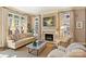 Inviting living room with a fireplace, large windows, hardwood floors, and comfortable seating at 2021 Nolen Park Ln, Charlotte, NC 28209