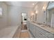 Bathroom features double sinks, soaking tub, and access to the primary bedroom at 2021 Nolen Park Ln, Charlotte, NC 28209