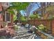 Charming patio with stone flooring, brick accents, and cozy outdoor seating at 2021 Nolen Park Ln, Charlotte, NC 28209