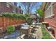 Beautiful patio with stone flooring, brick walls, and comfortable seating, nestled in lush landscaping at 2021 Nolen Park Ln, Charlotte, NC 28209
