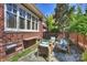 Inviting outdoor patio featuring comfortable seating, a low brick wall, and manicured greenery at 2021 Nolen Park Ln, Charlotte, NC 28209