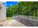 An amazing backyard deck with furniture set, fire pit, egg chair, a patch of artificial turf, and a small pool at 20827 Brinkley St, Cornelius, NC 28031