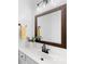 Bathroom featuring a large framed mirror, white cabinets, sleek black faucet, and stylish decor at 20827 Brinkley St, Cornelius, NC 28031