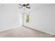 Bright bedroom with neutral carpet, ceiling fan, and a window providing natural light at 20827 Brinkley St, Cornelius, NC 28031