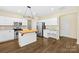 Bright kitchen with wooden island, stainless steel appliances, built-in desk, and hardwood floors at 20827 Brinkley St, Cornelius, NC 28031
