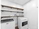 Neat laundry room with modern washer and dryer, shelves, and neutral walls at 20827 Brinkley St, Cornelius, NC 28031