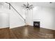 Living room showcasing a fireplace, staircase, lots of natural light, and hardwood floors at 20827 Brinkley St, Cornelius, NC 28031