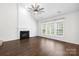 Living room with a fireplace, large windows providing natural light, and hardwood floors at 20827 Brinkley St, Cornelius, NC 28031