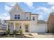 Charming two-story home with a welcoming front porch and manicured landscaping at 2105 Moss Bluff Dr, Mint Hill, NC 28227