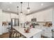 Well-lit kitchen featuring an island with barstools, sleek countertops, and stainless steel appliances at 2105 Moss Bluff Dr, Mint Hill, NC 28227