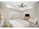 Inviting main bedroom with a tray ceiling, a ceiling fan, and a cozy sitting area at 2105 Moss Bluff Dr, Mint Hill, NC 28227