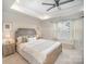 Serene main bedroom with a tray ceiling, comfortable furnishings, and plenty of natural light at 2105 Moss Bluff Dr, Mint Hill, NC 28227