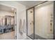 Modern shower featuring stylish tile and a sleek glass enclosure, adjacent to the walk-in closet at 2105 Moss Bluff Dr, Mint Hill, NC 28227