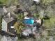 An overhead shot exhibits the house with a pool, trees, yard, and patio at 2132 Rolston Dr, Charlotte, NC 28207