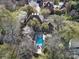 An aerial view of a property showcases the pool, patio, and surrounding landscaping at 2132 Rolston Dr, Charlotte, NC 28207
