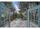 Inviting back porch with stone tiles looks out to the lush backyard and swimming pool at 2132 Rolston Dr, Charlotte, NC 28207