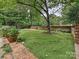 A charming backyard with manicured lawn and privacy wall is perfect for entertaining at 2132 Rolston Dr, Charlotte, NC 28207