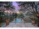 Stunning backyard view from balcony featuring pool, gorgeous landscaping, and evening sky at 2132 Rolston Dr, Charlotte, NC 28207