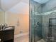 Bathroom features a gray tiled shower with glass door, a sink with a black vanity, and tiled floors at 2132 Rolston Dr, Charlotte, NC 28207