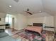 Finished attic bedroom space with seating area, hardwood floors, and custom built-in shelves at 2132 Rolston Dr, Charlotte, NC 28207