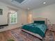 Inviting bedroom boasts a plush bed, skylight, and a decorative area rug on hardwood flooring at 2132 Rolston Dr, Charlotte, NC 28207