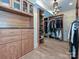 Spacious walk-in closet with custom wood shelving, cabinets, drawers, and a unique chandelier at 2132 Rolston Dr, Charlotte, NC 28207