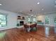 Open dining room featuring hardwood floors, bright windows, and a stone fireplace at 2132 Rolston Dr, Charlotte, NC 28207