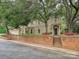 Charming home exterior with brick landscaping, mature trees, and a well-manicured lawn at 2132 Rolston Dr, Charlotte, NC 28207