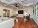 A large living room space with a large TV, windows, and comfortable seating area at 2132 Rolston Dr, Charlotte, NC 28207