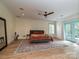 Main bedroom boasts a ceiling fan, light-colored walls, and a large rug at 2132 Rolston Dr, Charlotte, NC 28207