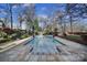A stunning in-ground pool with tiled surround and lush landscaping is great for relaxing at 2132 Rolston Dr, Charlotte, NC 28207