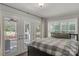 Charming bedroom with French doors to a screened patio and shuttered windows at 22 Honeysuckle Ln, Clover, SC 29710