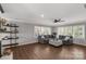 Bright living room features hardwood floors, large windows with shutters, and a comfortable gray sectional at 22 Honeysuckle Ln, Clover, SC 29710