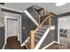 An open staircase features wood and white metal railings, leading to the upper level of the home at 22 Honeysuckle Ln, Clover, SC 29710