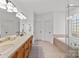 Spacious bathroom featuring double vanities, ceramic tile flooring, and a soaking tub at 221 Colony Dr, Mooresville, NC 28115