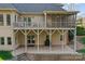 View of exterior with covered porch and stairs to patio at 221 Colony Dr, Mooresville, NC 28115