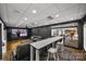 Entertaining game room boasts black walls, a large screen tv, and a bar with seating at 221 Colony Dr, Mooresville, NC 28115