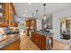 Gourmet kitchen features a center island with granite countertops, stainless steel appliances, and wood cabinetry at 221 Colony Dr, Mooresville, NC 28115