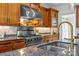 Close up of a modern kitchen with Viking range, stainless steel hood, and granite countertops at 221 Colony Dr, Mooresville, NC 28115