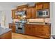 Charming kitchen features a stainless steel range with wood cabinets, tile backsplash, and granite countertops at 221 Colony Dr, Mooresville, NC 28115