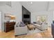 Modern living room featuring a fireplace, neutral furniture, and high ceilings at 221 Colony Dr, Mooresville, NC 28115