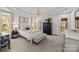 Elegant main bedroom with a four-poster bed, tray ceilings, a chandelier, and access to the outdoors at 221 Colony Dr, Mooresville, NC 28115