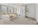 Airy main bedroom with statement lighting, a four poster bed, built in closet and neutral wallpaper at 221 Colony Dr, Mooresville, NC 28115
