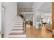Open staircase with hardwood floors, leading to the living spaces with lots of natural light at 221 Colony Dr, Mooresville, NC 28115
